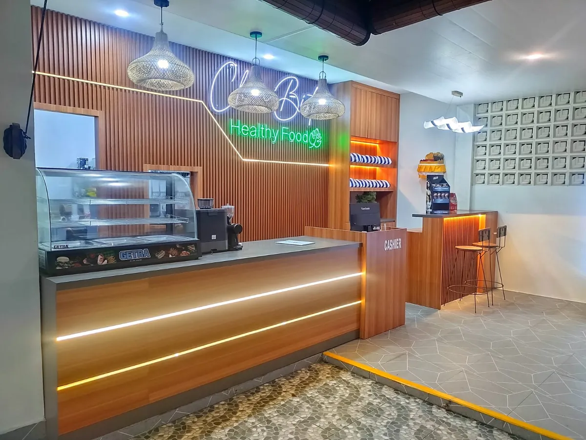 Wooden counter with neon Healthy Food sign